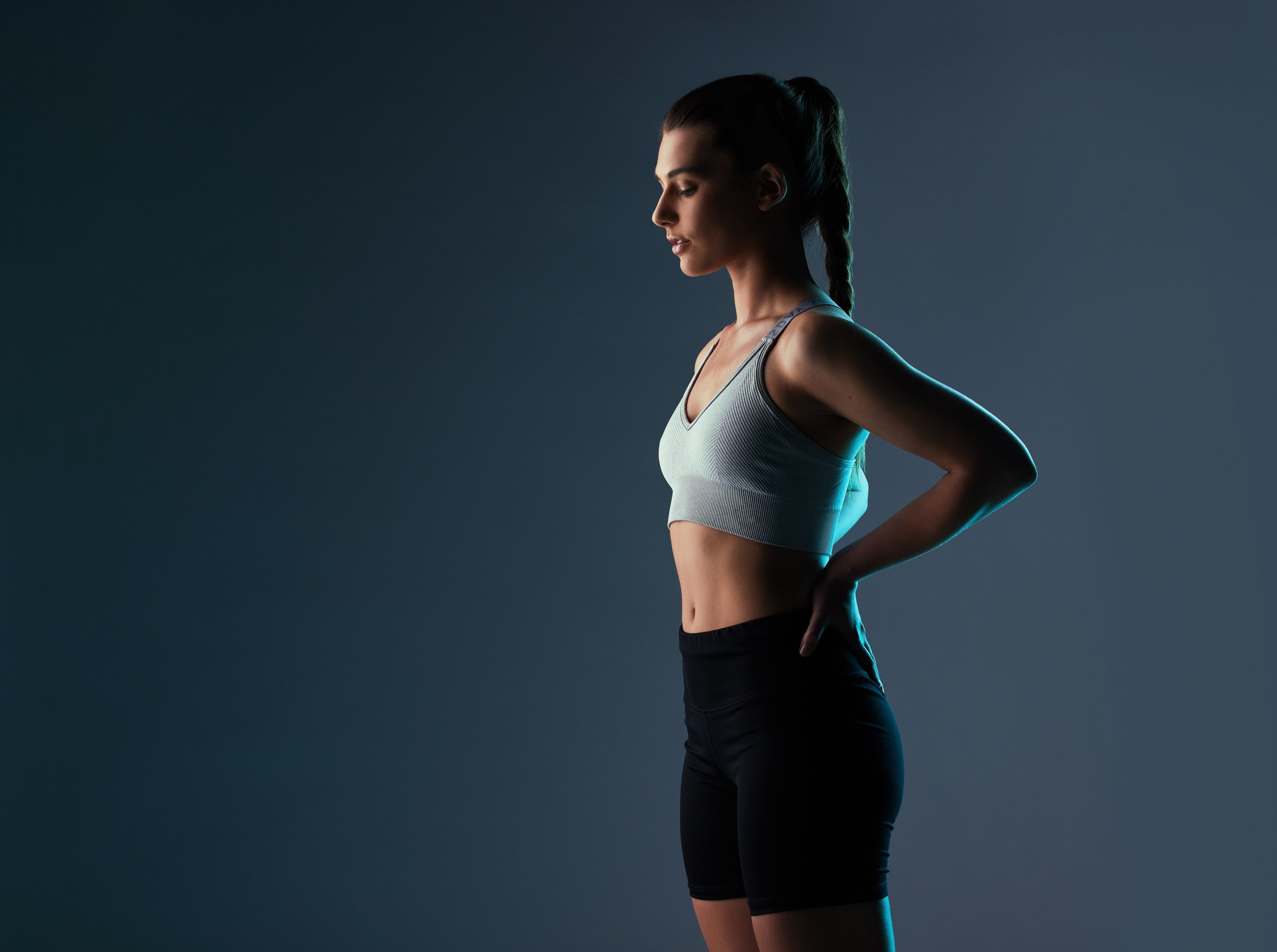 Woman in fitness attire with hands on hips