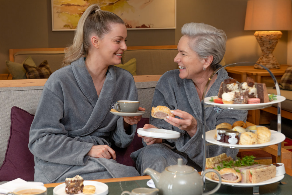 Mother and daughter enjoying afternoon tea in spa