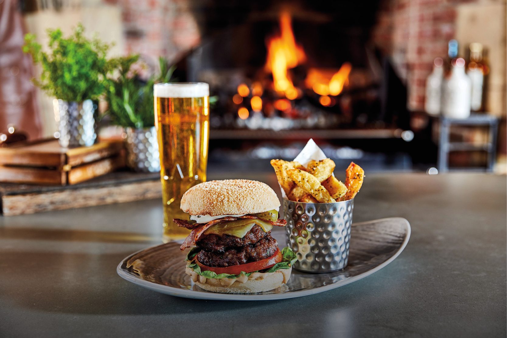 Burger in front of open fire grill